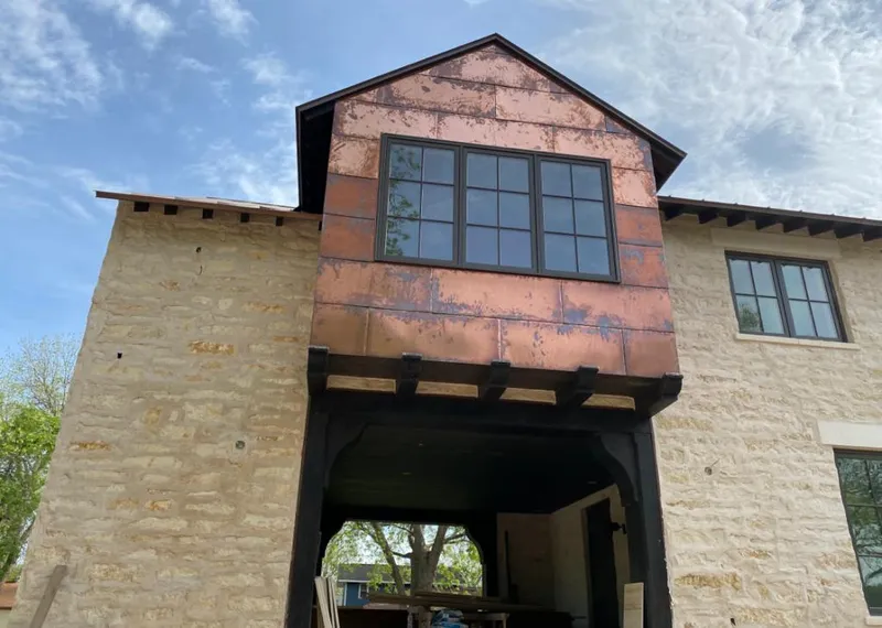 Copper metal panel facade on a stone building for Roof Repair in Indianapolis