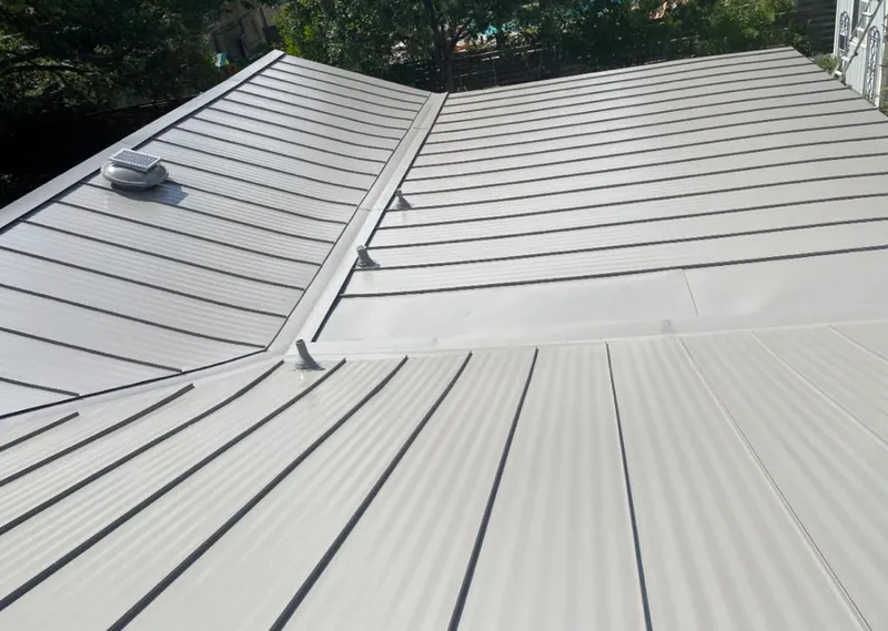 Solar attic fan installed on a metal roof for Roof Ventilation in Indianapolis